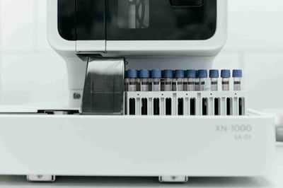 Close view of an autosampler with capped vials loaded into a biophysical analyzer, representing physicochemical testing for stability, purity, aggregation, and critical quality attributes.